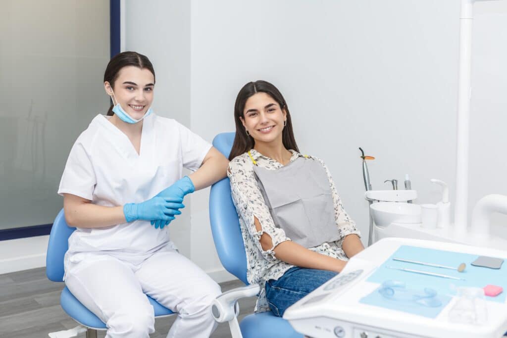 A,Dentist,And,A,Patient,Pose,For,A,Picture,In